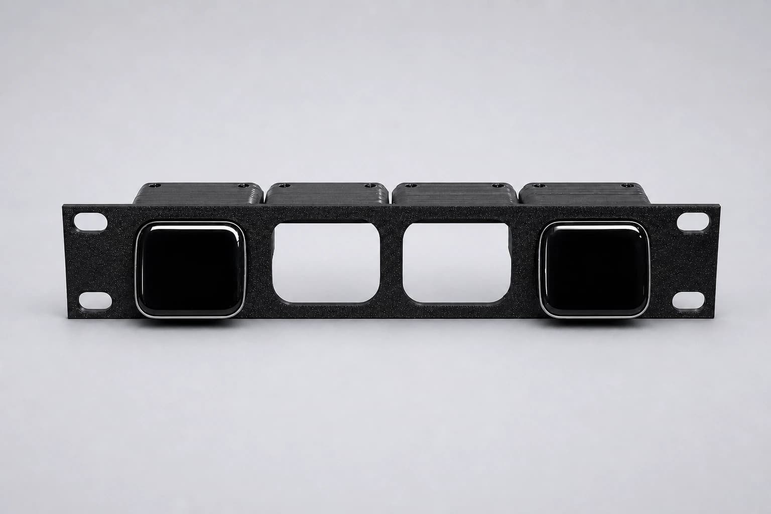 Front studio view of the four-position JetKVM rack mount with two outer devices installed and two inner positions open
