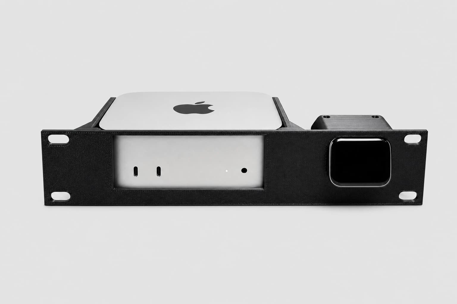 Front studio view of a 2024 Apple Mac mini and JetKVM installed in the black 10-inch rack mount kit
