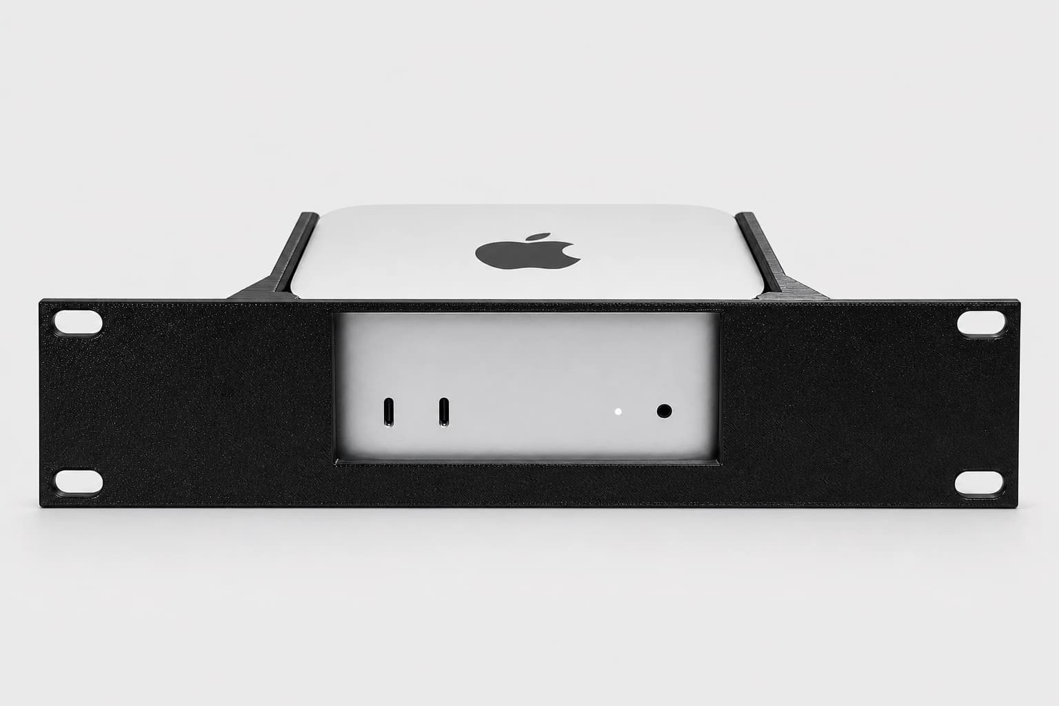 Front studio view of a 2024 Apple Mac mini installed in the black 10-inch rack mount kit
